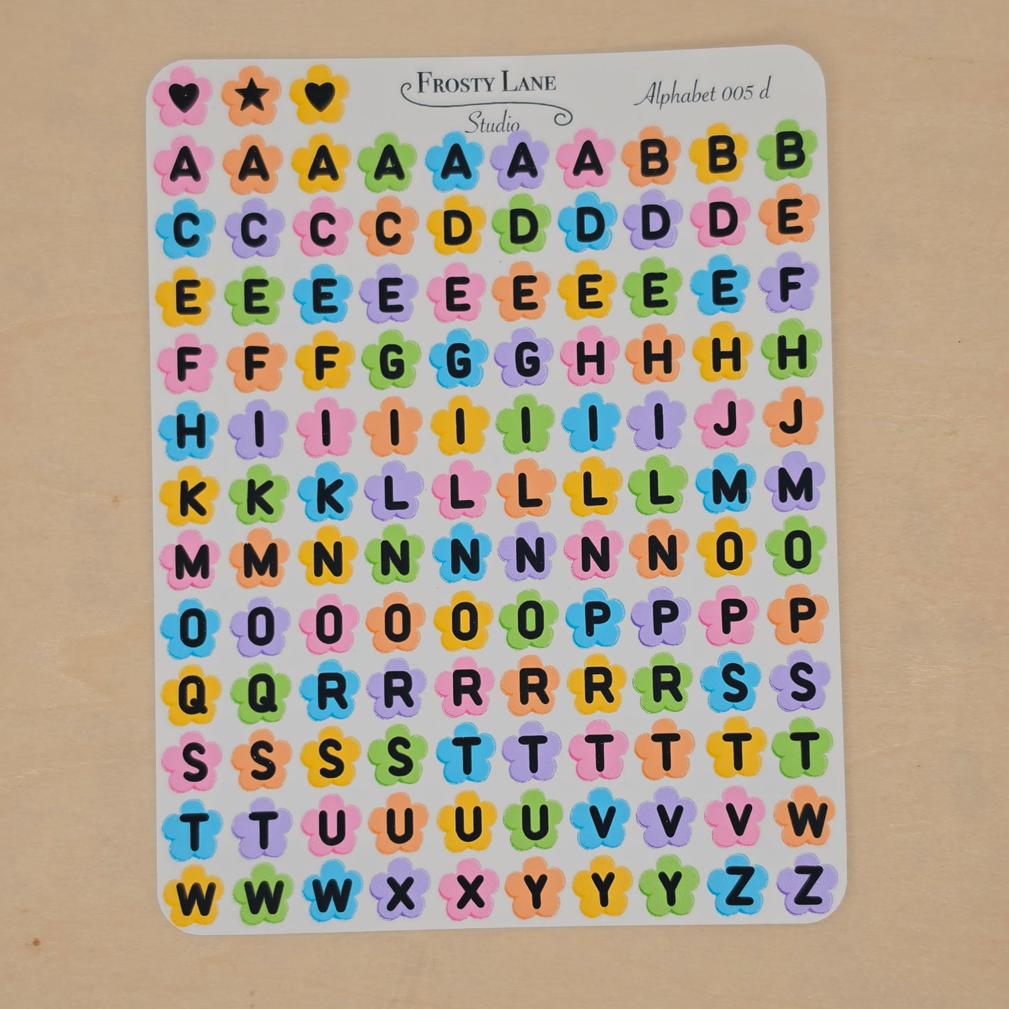 Alphabet 005.d. black letters and rainbow flower