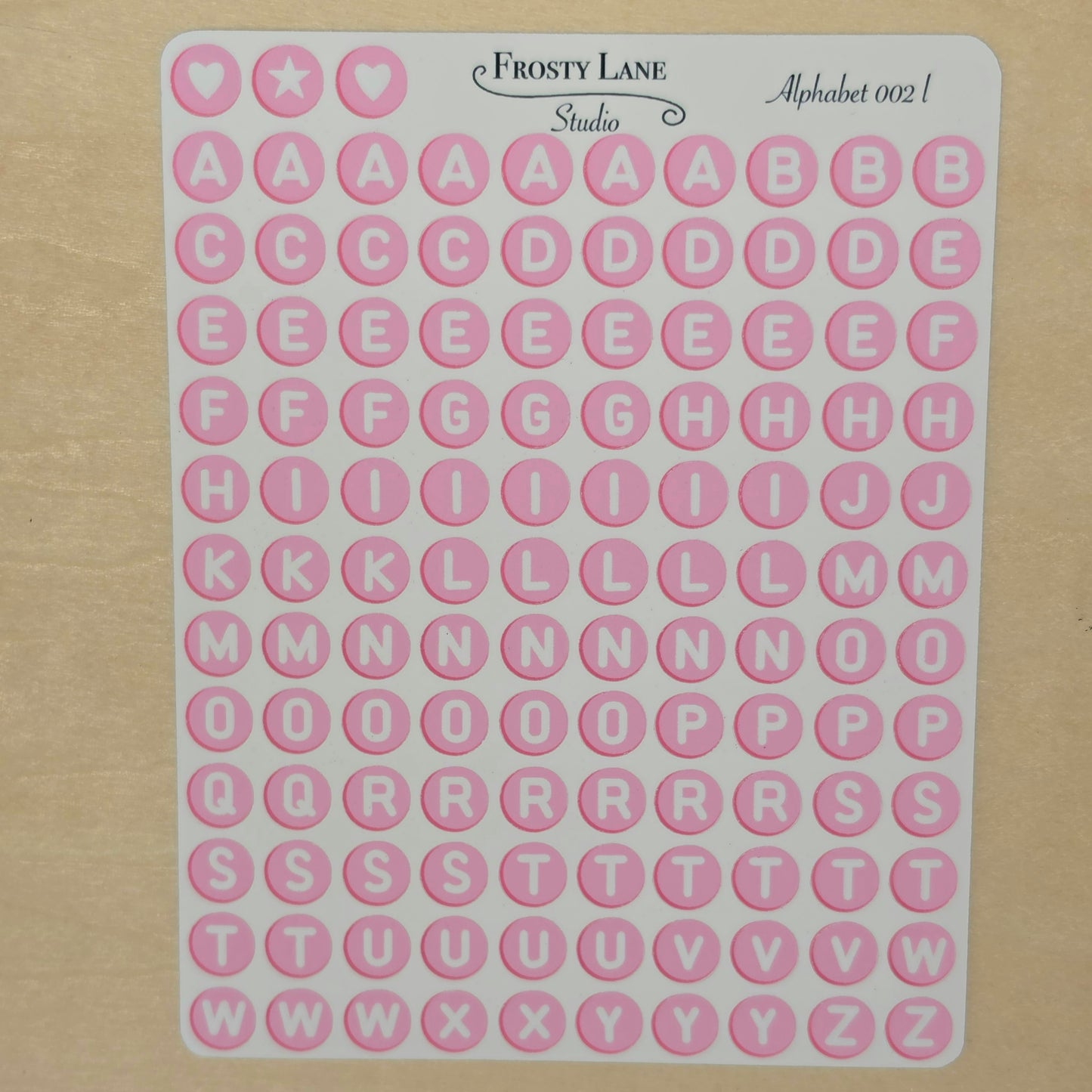 Alphabet 002.l. white letters and pink circle