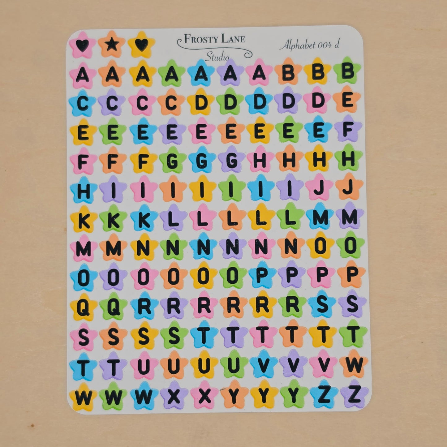Alphabet 004.d black letters and rainbow star