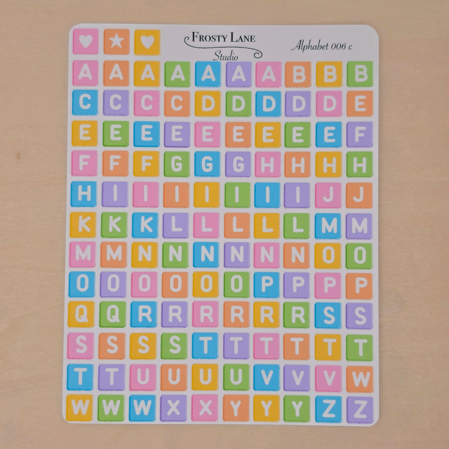 Alphabet 006.c white letters and rainbow square